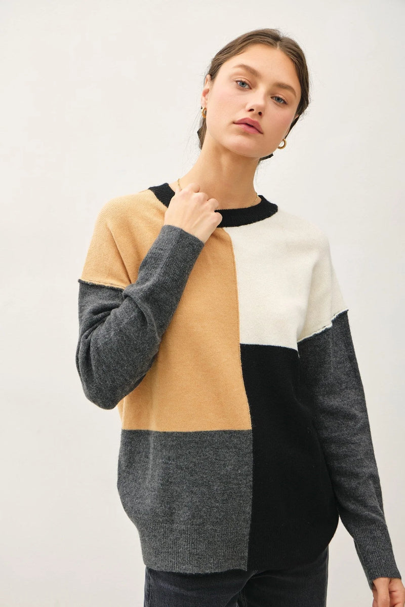 Color blocked crew neck sweater in beige, white, and gray sections