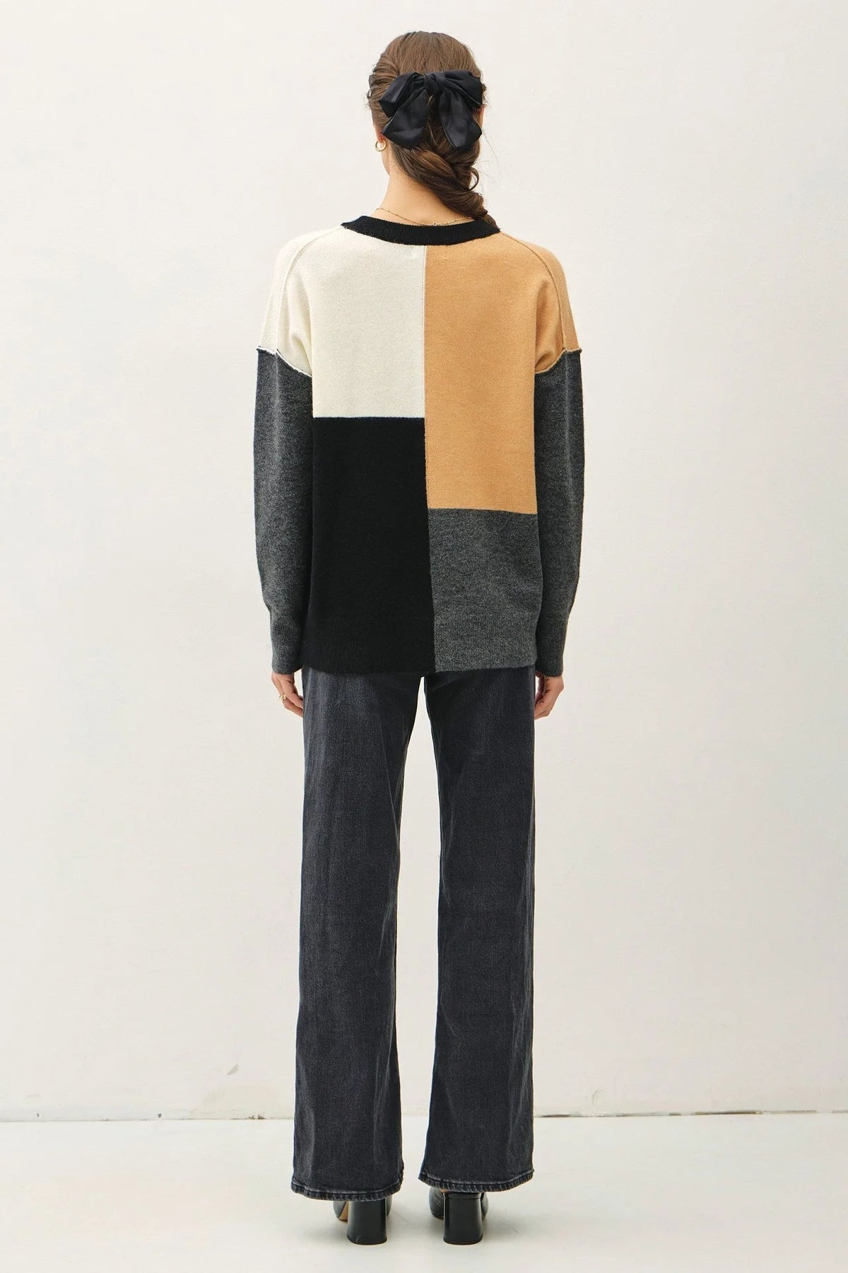 Person wearing a Crew Neck Color Blocked Sweater featuring geometric patterns