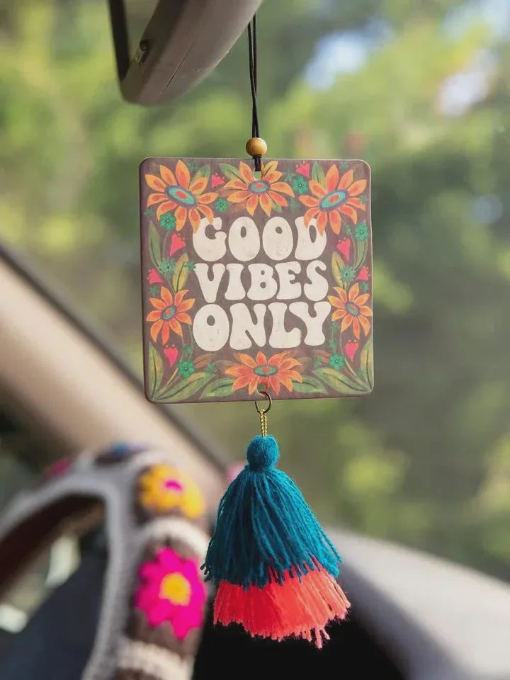 Colorful boho car air freshener with Good Vibes Only text and floral tassels