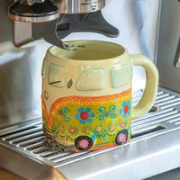 Colorful folk art coffee mug shaped like a Volkswagen van with floral designs