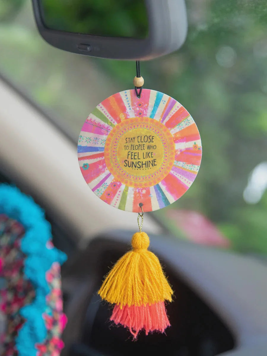 Colorful boho circular car air freshener with inspirational message and tassel