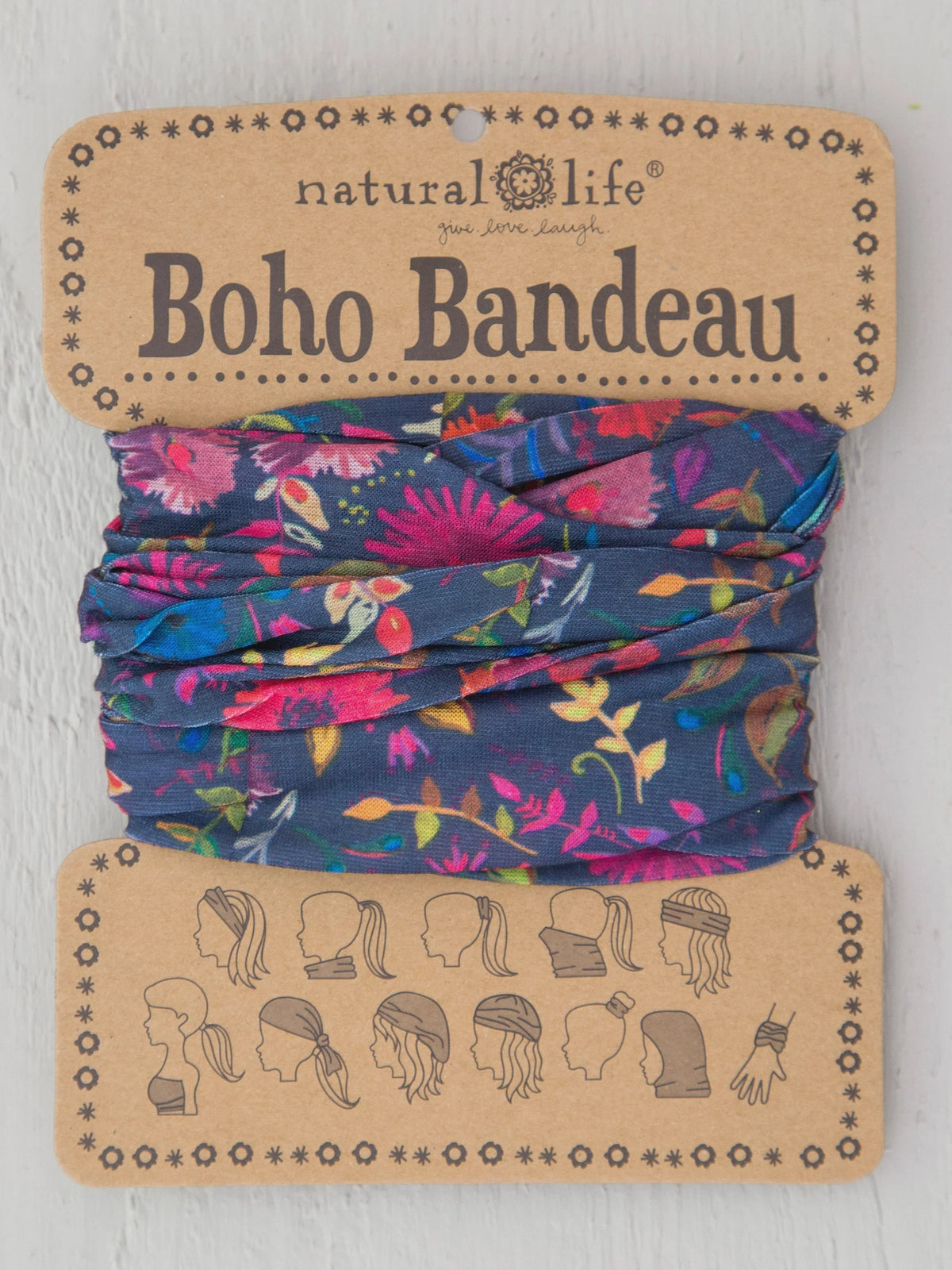 Colorful floral patterned fabric headband in branded packaging for Boho Bandeau Navy Wild Flowers