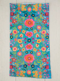 Colorful floral beach towel with vibrant teal, perfect for a boho free spirit