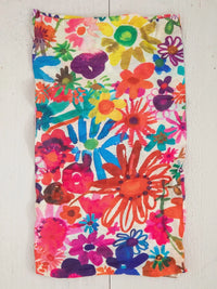 Bright floral garden headband displayed on a white wall as a colorful tube top accessory