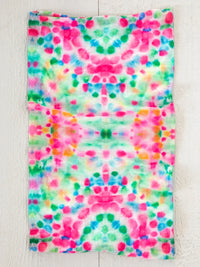 Colorful tie-dye fabric towel with pink and green splotches for boho free spirit style