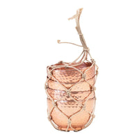 Copper-colored hammered metal cup with jute tie for a boho-inspired decor