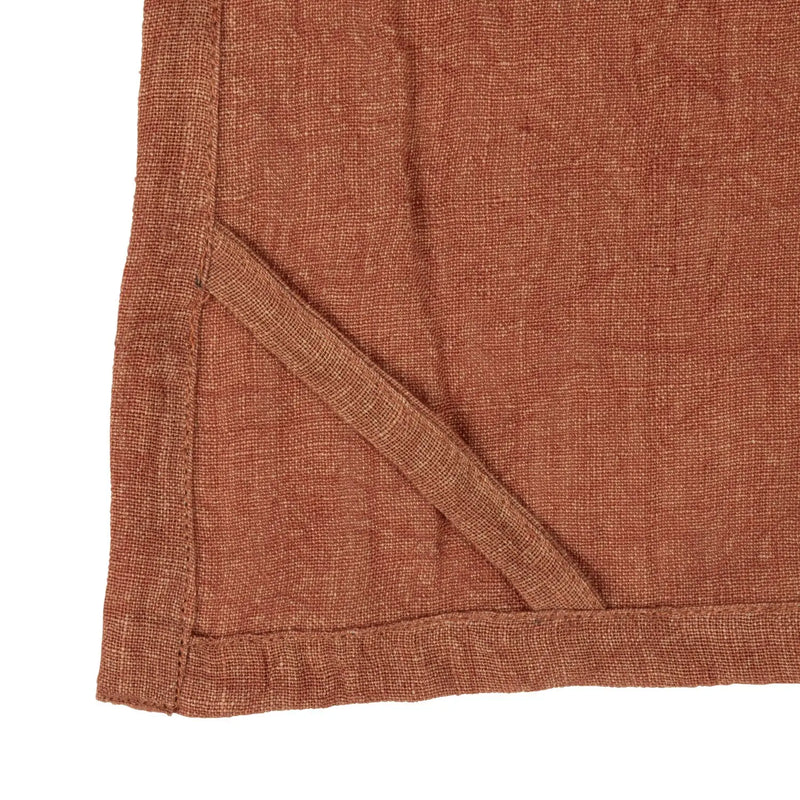 Corner detail of an oversized stonewashed linen tea towel with pocket and stitching