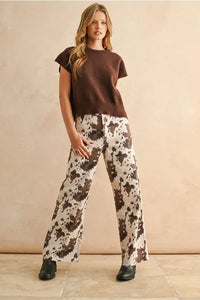 Loose fit short sleeve sweater with cow print wide-leg pants and leather boots