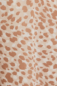 Cream and brown abstract animal print fabric for stylish animal print midi dress