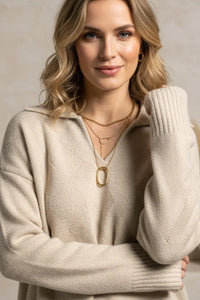 Cream cable knit Prudence Sweater with gold necklace and earrings