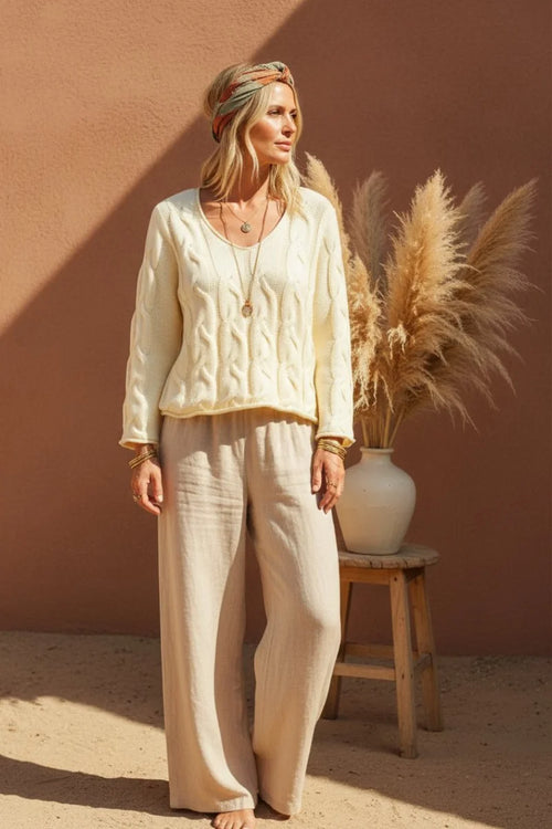 Cream-colored V-neck cable pullover sweater with relaxed fit