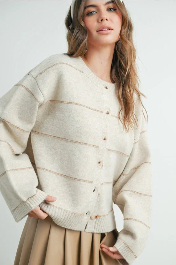 Cream-colored striped cardigan with button front and ruffled hem