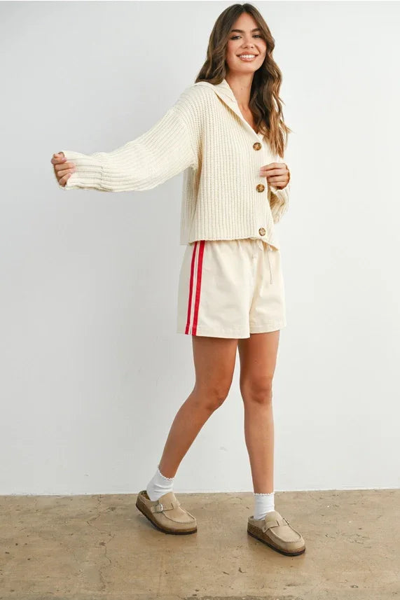 Knit collared V-neck buttoned cardigan in cream with white shorts