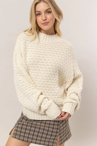 Cream-colored chunky knit high neck sweater from Shop Daisy for women’s boho chic clothing