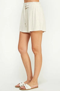 Cream-colored high-waisted soft linen blend shorts with tie belt and double buckle detail