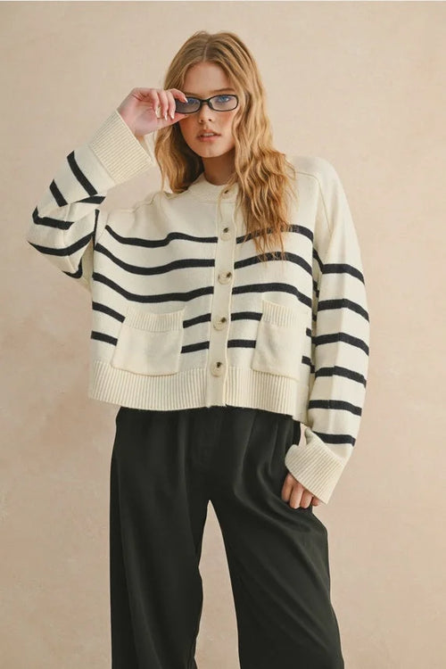 Cream-colored knit cardigan with bold black stripe pattern button front