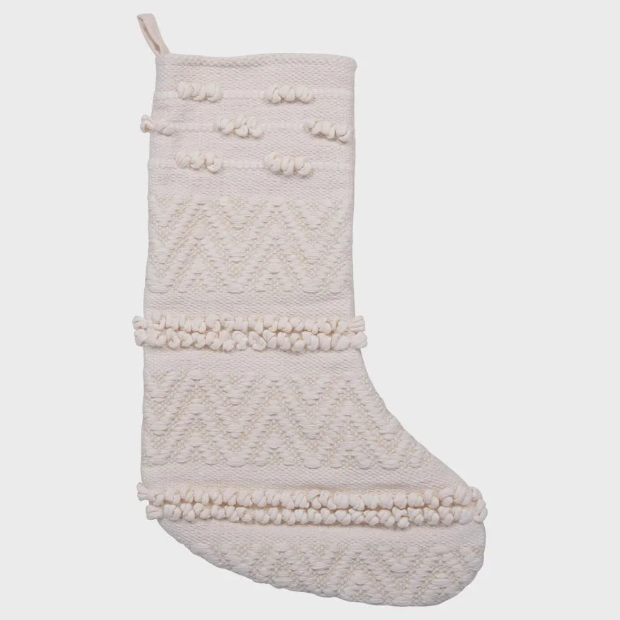 Cream-colored woven cotton blend Christmas stocking with textured patterns and pom-poms