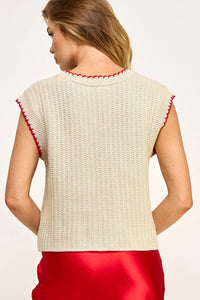 Cream-colored sleeveless vest sweater with red trim detailing for casual elegance