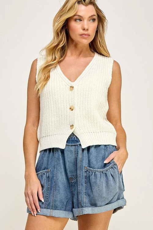 Cream-colored casual sweater vest with buttons paired with denim shorts for a stylish look