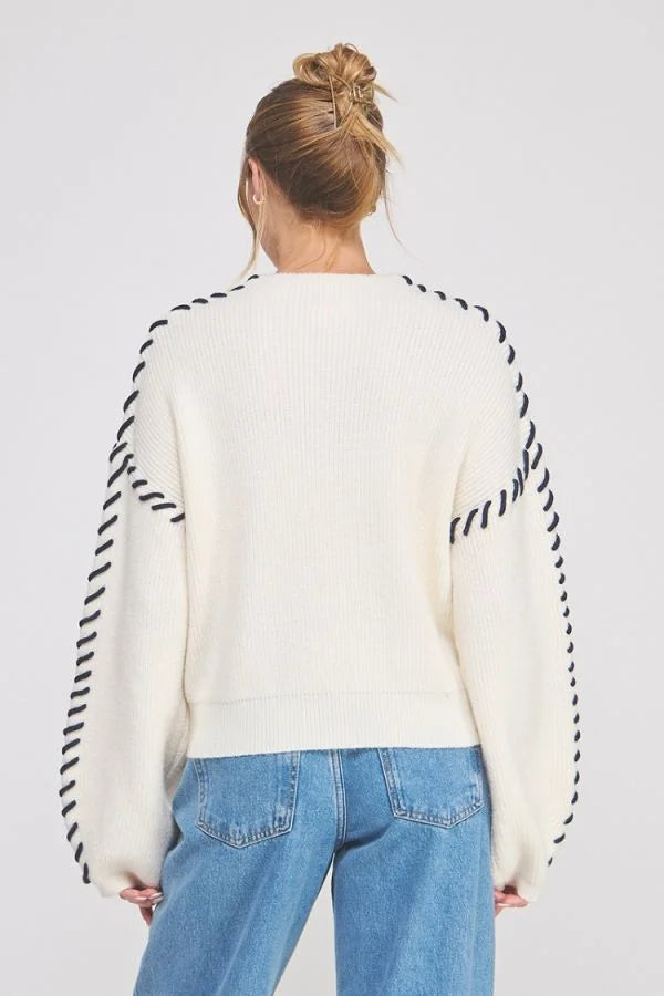 Lofty Mock Neck Cream Sweater with Black Zigzag Stitch Details