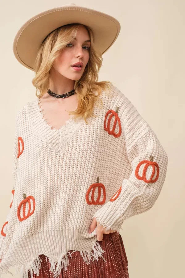 Cream-colored knit sweater with pumpkin designs, perfect for women’s boho chic clothing