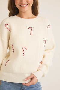 Cream-colored knit round neck long sleeve candy cane pullover sweater with embellishments