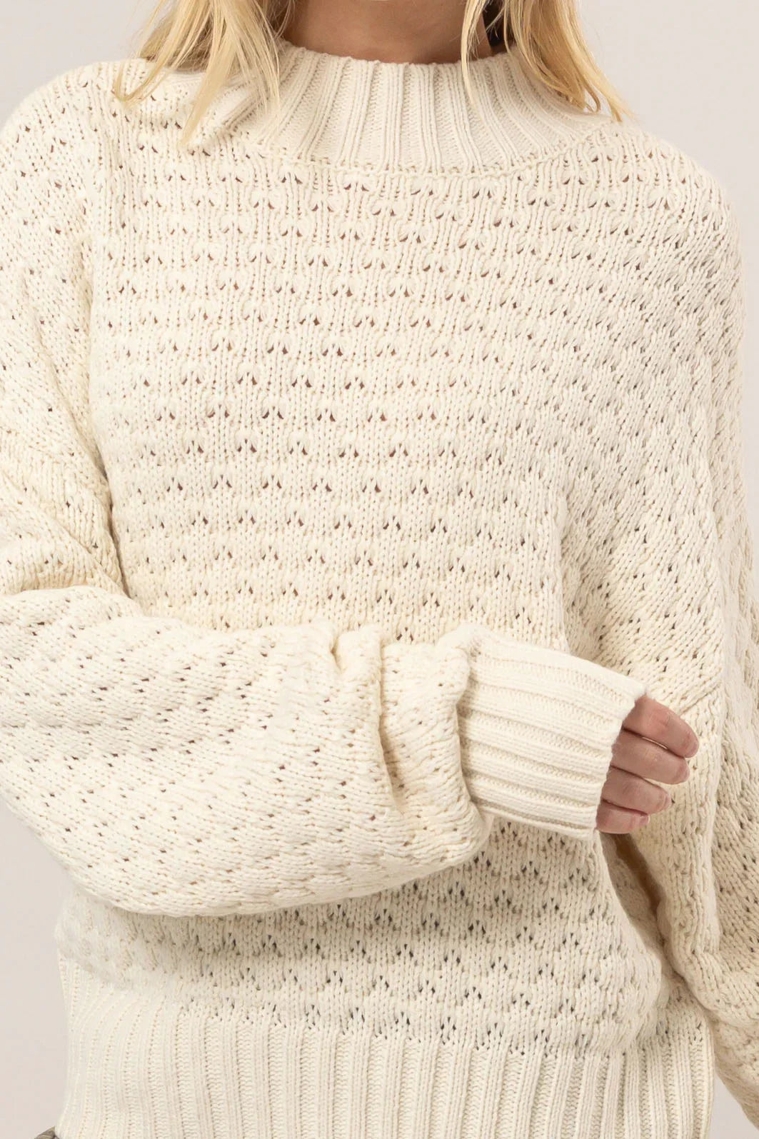 Cream-colored textured high neck sweater with wide sleeves from Shop Daisy, perfect for women’s boho chic clothing