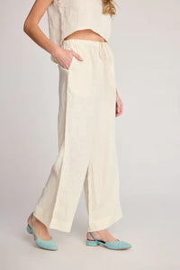 Cream-colored linen pants with side slits from SUNDAY RITUAL DAHLIA PANTS, perfect for women’s boho chic clothing and shop Daisy