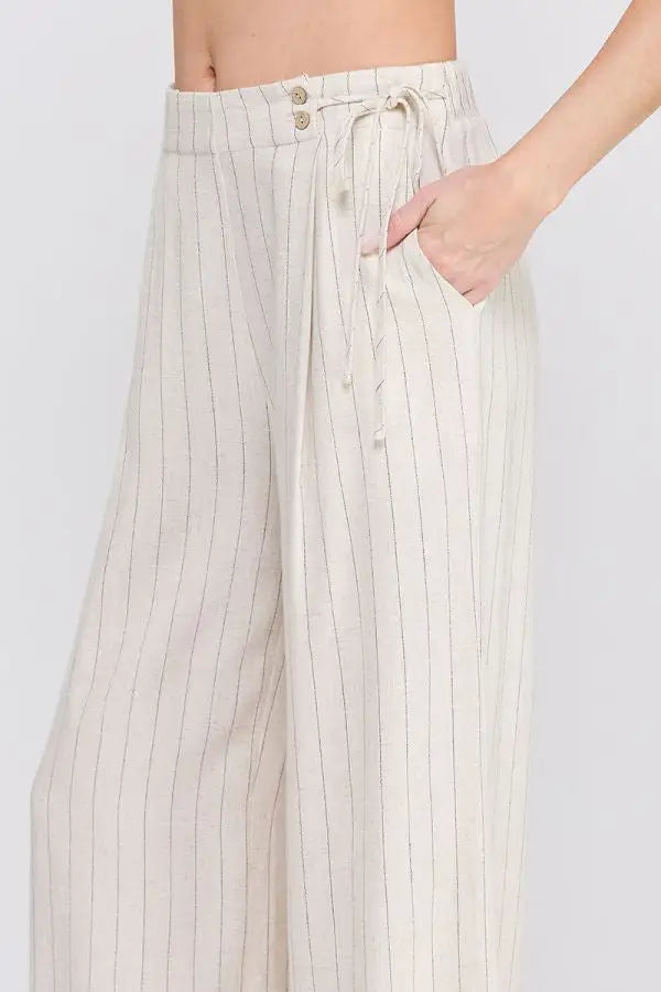 Cream-colored pinstriped wide-leg pants with pockets, ideal for women’s boho chic clothing