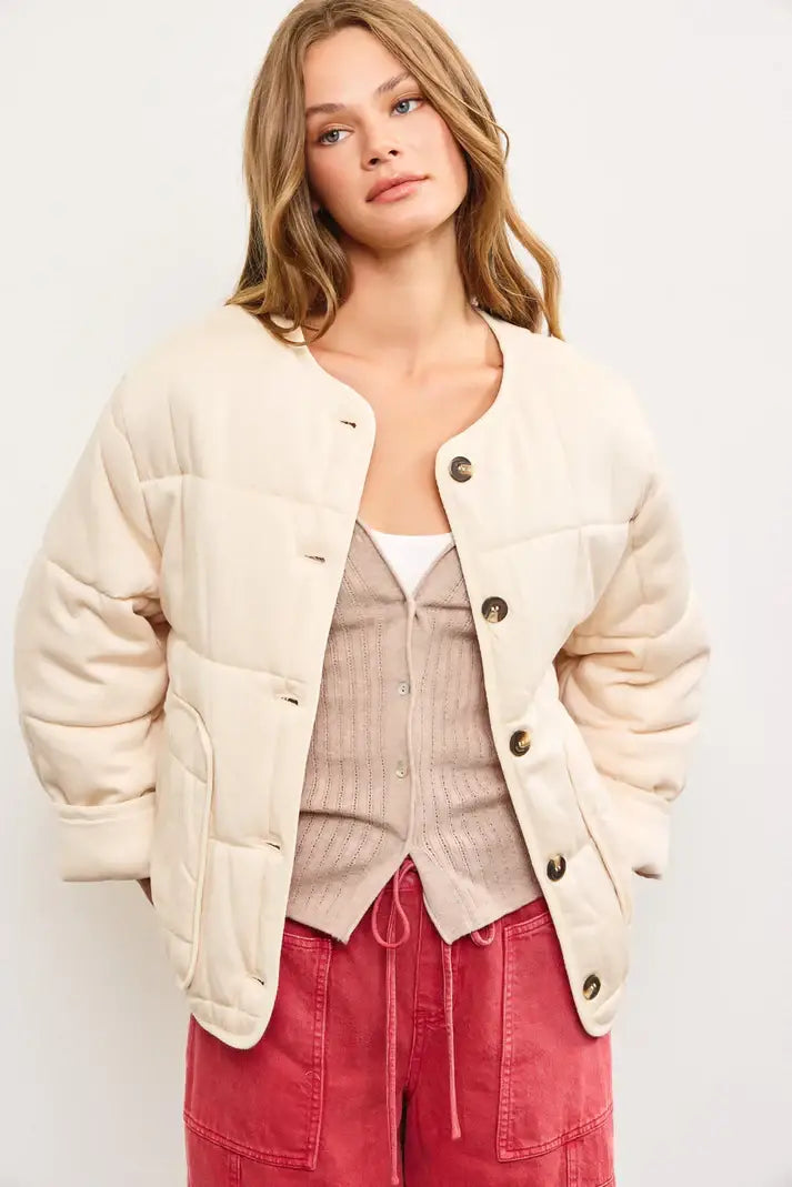 Cream-colored quilted oversized jacket with puffy sleeves for stylish outerwear