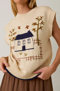 Cream-colored crow neck sleeveless graphic sweater with house and tree design