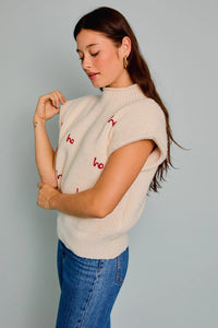 Cream-colored sleeveless sweater with red embroidery, perfect for women’s boho chic clothing