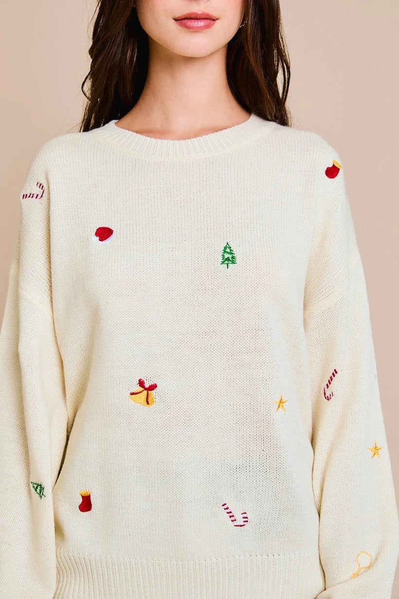 Cream-colored round neck long sleeve embroidered sweater with colorful designs