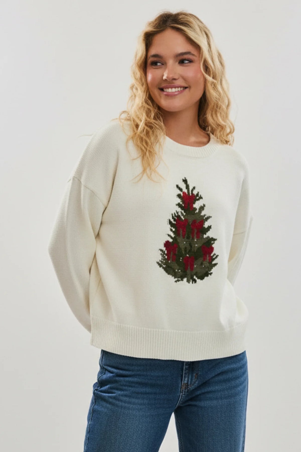 Cream-colored knit Christmas tree sweater with red berries and green leaves