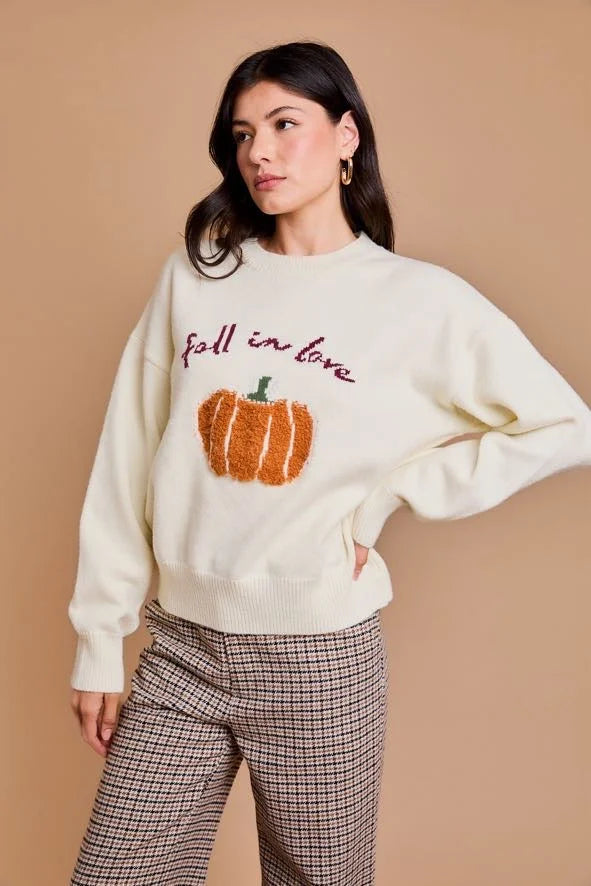 Cream-colored long sleeve sweater with pumpkin design and fall in love text