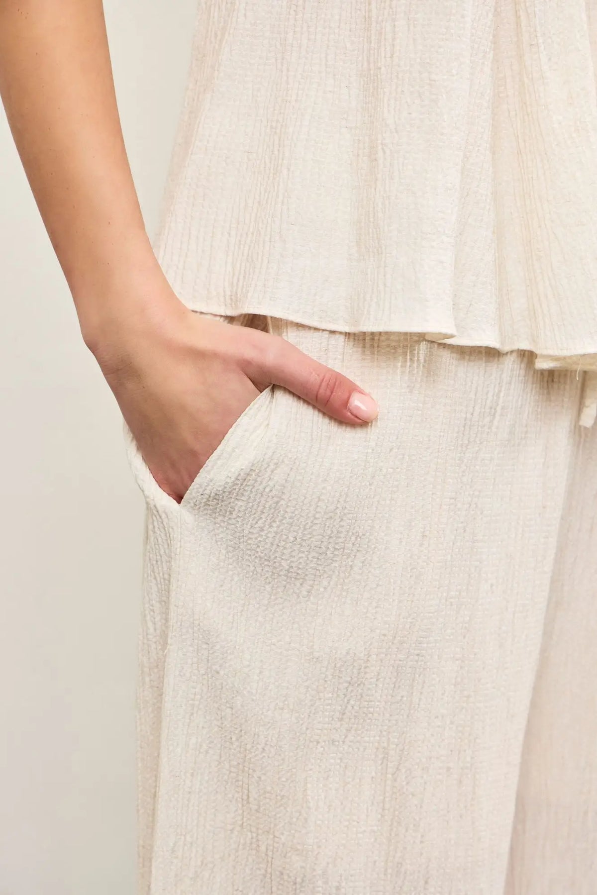 Cream-colored textured fabric wide leg pants with elastic waist for a stylish look