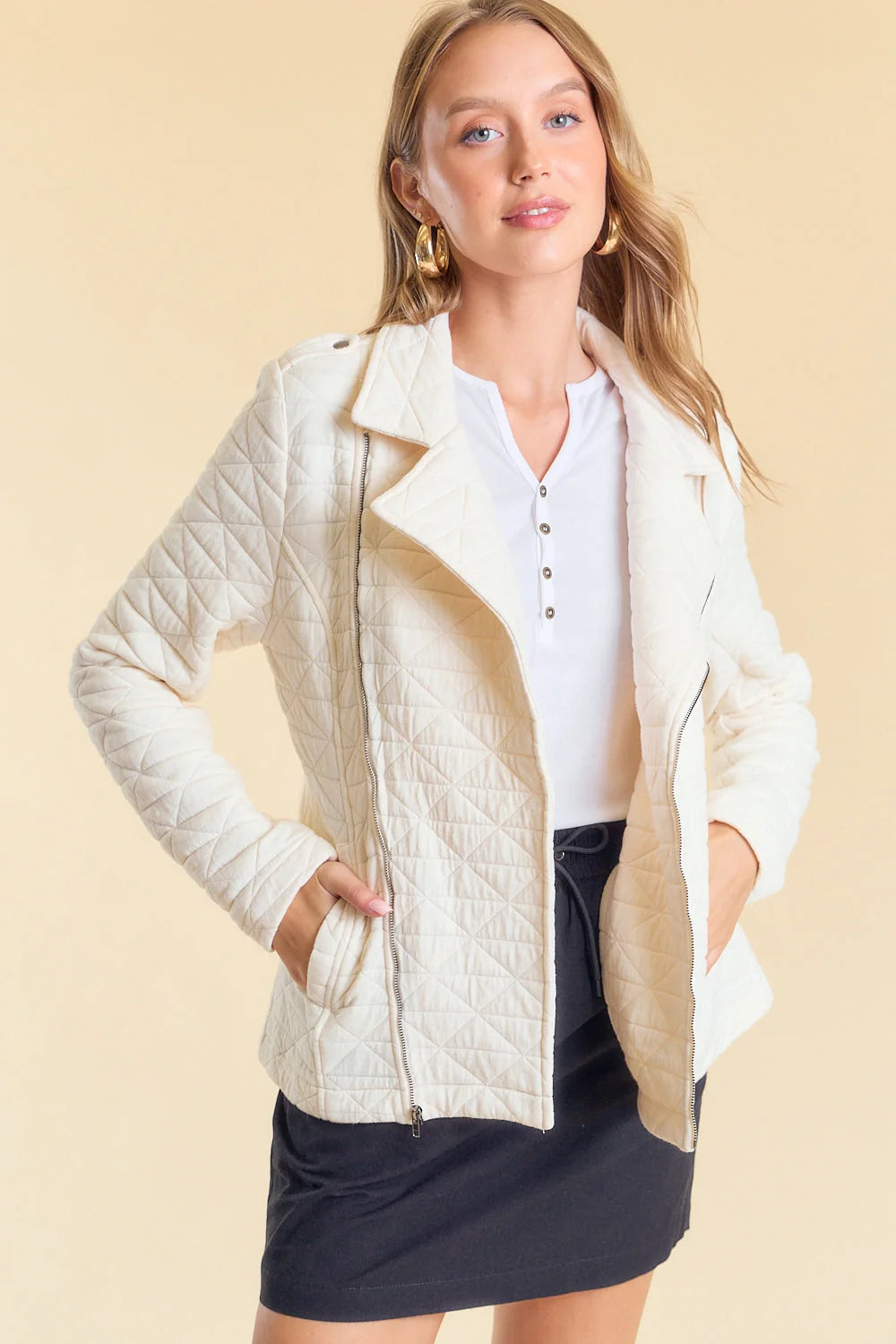 Cream-colored textured jacket with lapels over a white henley, showcasing the Washed Moto Jacket