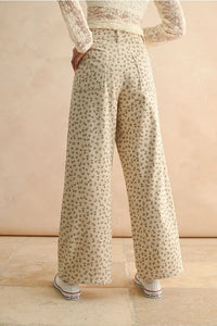Cream-colored floral printed corduroy pants with wide-leg design for a stylish look