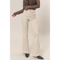 Cream-colored washed twill wide-leg jeans with frayed hems from Shop Daisy’s women’s boho chic clothing