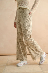 Cream-colored floral printed corduroy pants with wide-leg design for stylish comfort