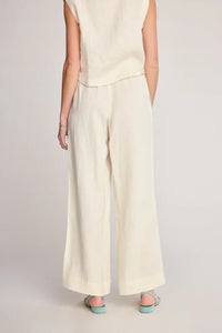 Cream-colored wide-leg pants from SUNDAY RITUAL DAHLIA PANTS, ideal for women’s boho chic clothing