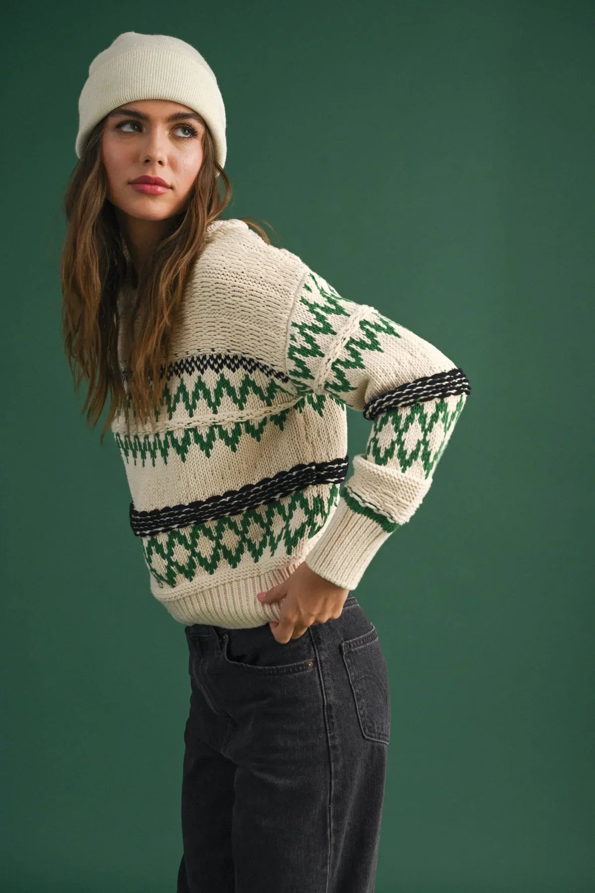 Cream-colored Aztec pattern sweater with geometric designs and white beanie