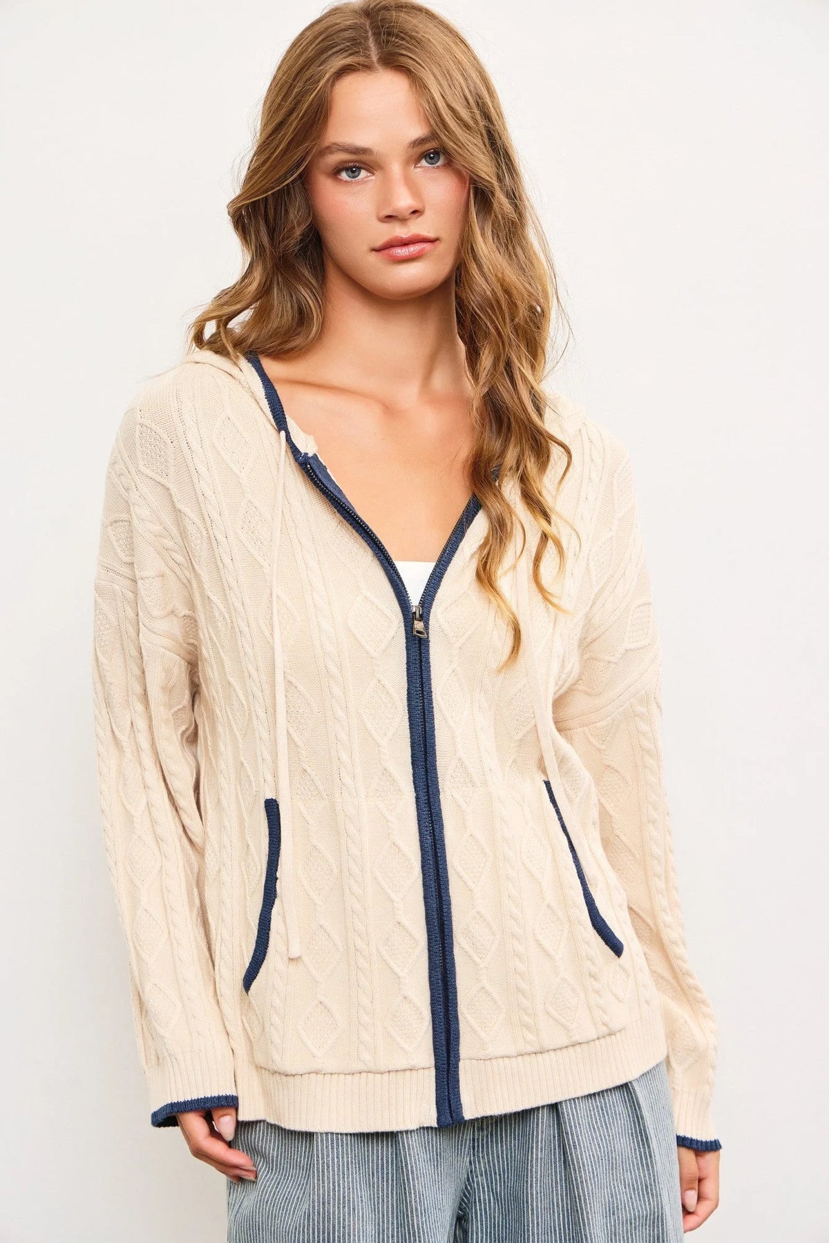 Cream-colored zip-up cardigan with navy trim, perfect for women’s boho chic clothing