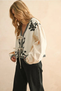 Floral patch detailed jacket with cream embroidered blouse and black floral accents