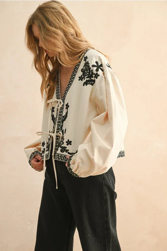 Floral patch detailed jacket with cream embroidered blouse and black floral accents