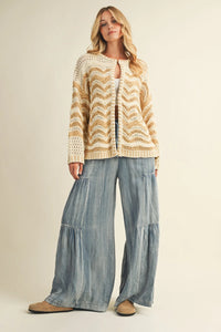 Cream and gold chevron-patterned open-knit cardigan paired with Ruffled Washed Denim Wide Pants