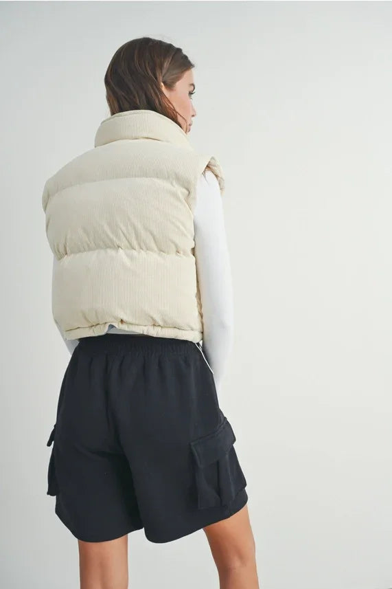 Fall Adoreme corduroy puffer vest with cream puffer, black cargo shorts, white long-sleeve shirt