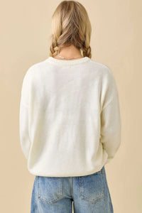 Loose-fitting cream pumpkin embroidered sweater with ribbed texture, stylish embroidered sweater