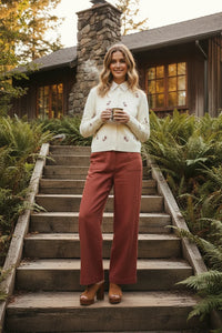 Candy cane embroidered fitted cardigan with rust pants and boots