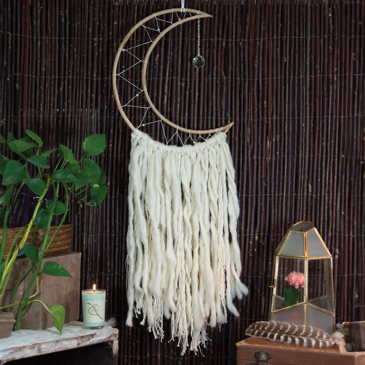 Crescent moon dream catcher wall hanging with white yarn tassels from Shop Daisy